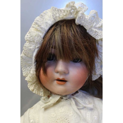 455 - An Arthur Schoenall and Hoffmeister bisque head doll, with rolling eyes, hair, parted lips and compo... 