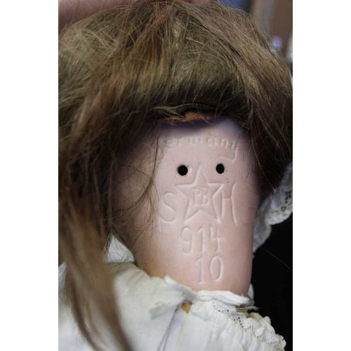 455 - An Arthur Schoenall and Hoffmeister bisque head doll, with rolling eyes, hair, parted lips and compo... 