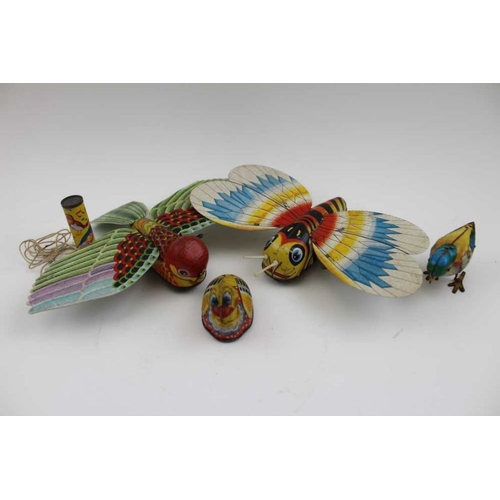 467 - A collection of printed tin plate toys, includes; a bird, a West German made open top car, a Japanes... 