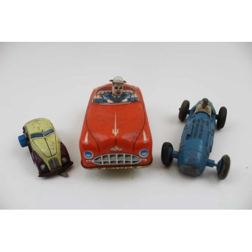 467 - A collection of printed tin plate toys, includes; a bird, a West German made open top car, a Japanes... 