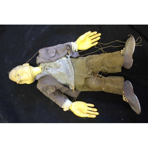 468 - A late 20th century stringed puppet in the form of a man dressed in conventional clothes, a jacket a... 