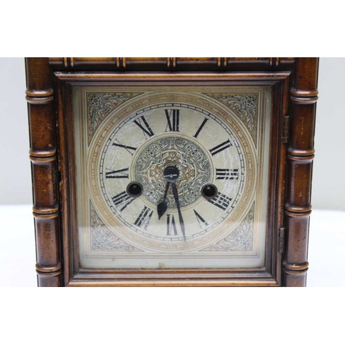 477 - A 19th century mantel clock, the mahogany case carved bamboo effect, the dial with Roman numerals, 3... 