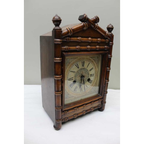 477 - A 19th century mantel clock, the mahogany case carved bamboo effect, the dial with Roman numerals, 3... 