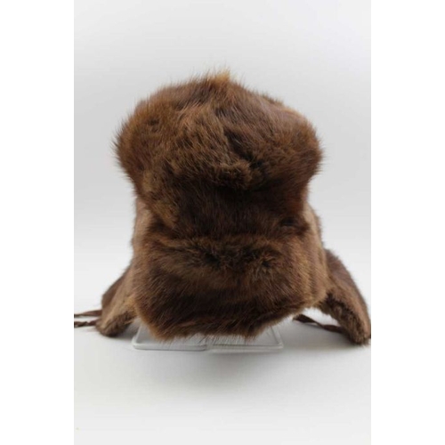 269 - A fur hat with ear flaps, bears label 