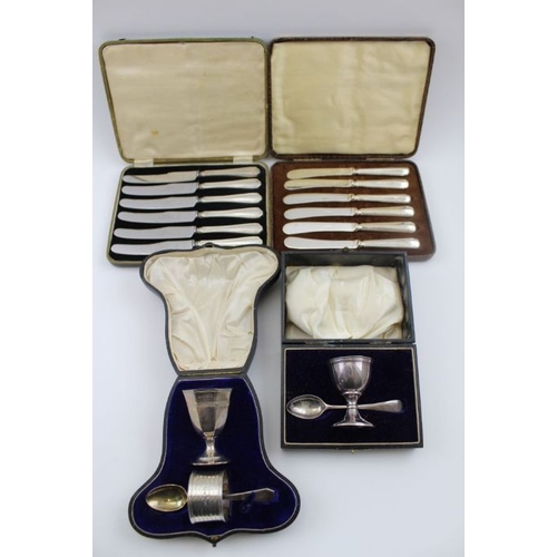 55 - Two cased silver sets of egg cups with spoons, and two cased sets of silver handled knives. silver w... 