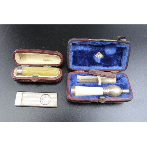 60 - Two Victorian cased silver mounted cigarette holders, together with two silver pencils, cigar cutter... 