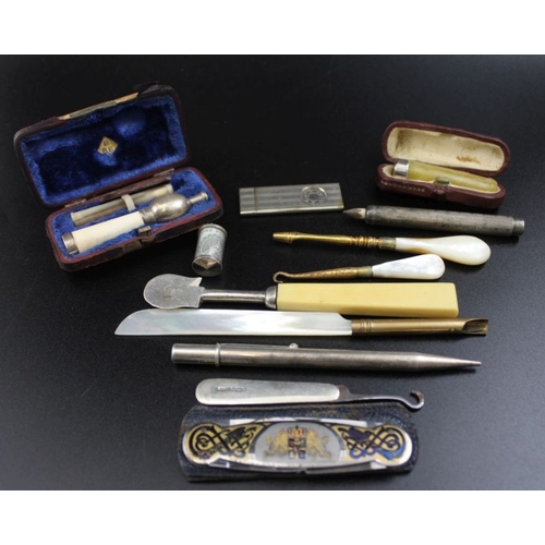 60 - Two Victorian cased silver mounted cigarette holders, together with two silver pencils, cigar cutter... 