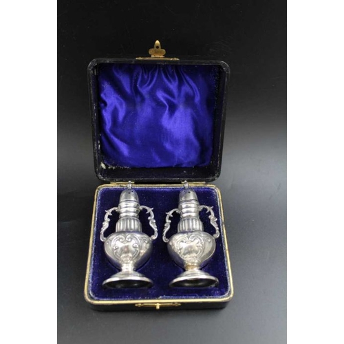 69 - Mitchell Bosley & Co. A pair of Victorian silver pepper pots, baluster form, fitted decorative side ... 