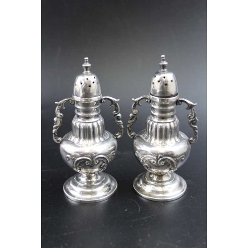 69 - Mitchell Bosley & Co. A pair of Victorian silver pepper pots, baluster form, fitted decorative side ... 