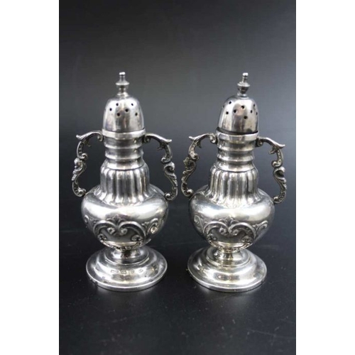 69 - Mitchell Bosley & Co. A pair of Victorian silver pepper pots, baluster form, fitted decorative side ... 