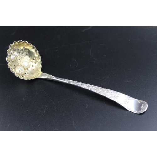 71 - A George III silver berry embossed sugar sifting ladle, gilded internal bowl, London 1800, 41g