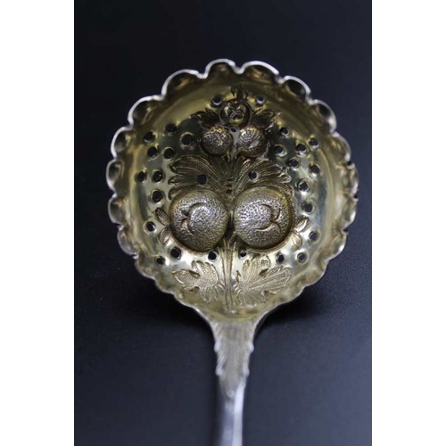 71 - A George III silver berry embossed sugar sifting ladle, gilded internal bowl, London 1800, 41g