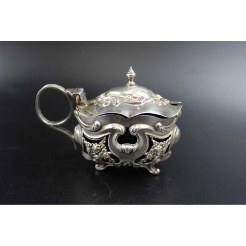 73 - Robert Pringle & Sons, a silver mustard pot, with hinged cover, richly embossed decoration, Chester ... 