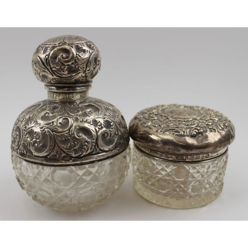 75 - An early 20th century embossed silver mounted cut glass grenade form scent bottle, London 1912, toge... 