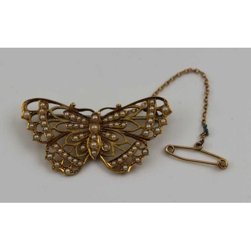 83 - A 15ct gold butterfly design brooch, inset seed pearls, 4cm, gross weight: 5.4g, fitted with safety ... 