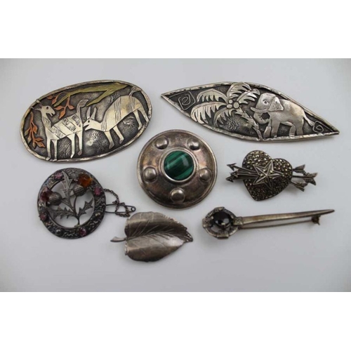 93 - A collection of silver and white metal Art jewellery, includes; a silver boss brooch, inset malachit... 