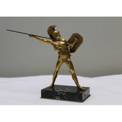 124 - A gilt bronze statue after the Antique, of a gladiator with shield and sword, on polished marble bas... 