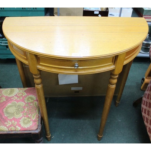 29 - An oak effect demi-lune table with single central drawer