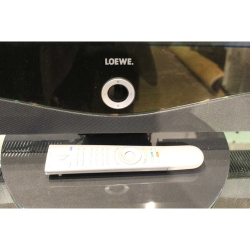 411 - A Loewe branded flat screen television with remote control