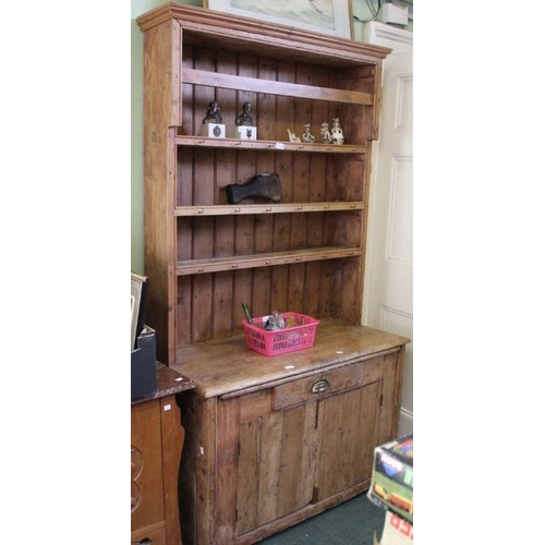 254 - A 19th century pine dresser with plate rack back and pull out slide.