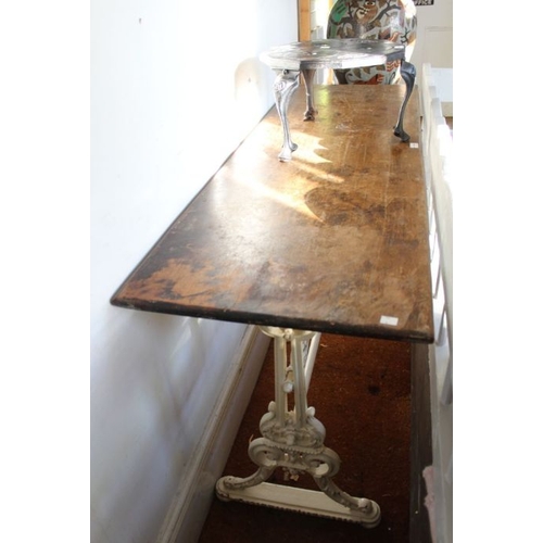 290 - A Victorian rectangular topped table on painted cast iron trestle base, 153cm long