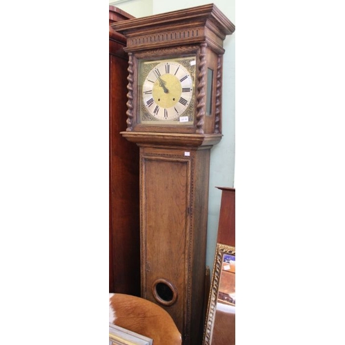 38 - A late 20th century oak longcase clock of the 1700's design. A square hood and barley twist chip  co... 