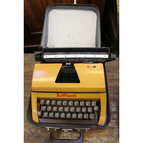 62 - A tartan cased Lilliput manual typewriter.