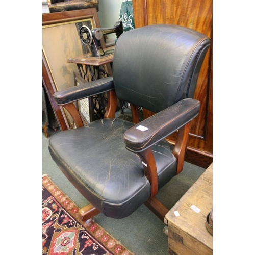 65 - A mid century mahogany swivel office chair.