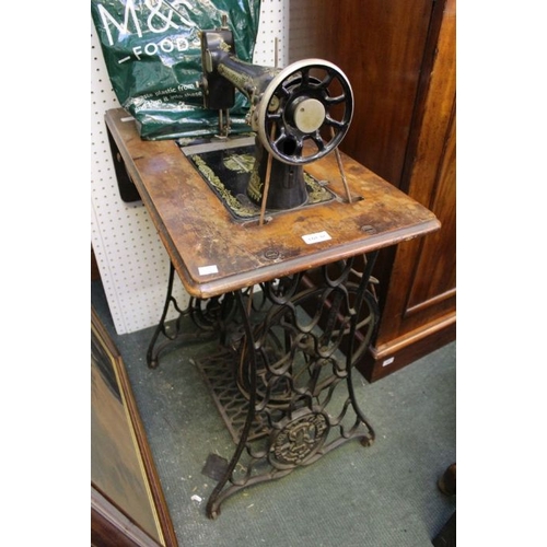 67 - A singer sewing machine on treadle base.