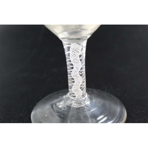 103 - An 18th century wine glass, cotton twist stem and conical foot, the bowl engraved 