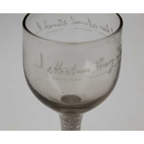 103 - An 18th century wine glass, cotton twist stem and conical foot, the bowl engraved 