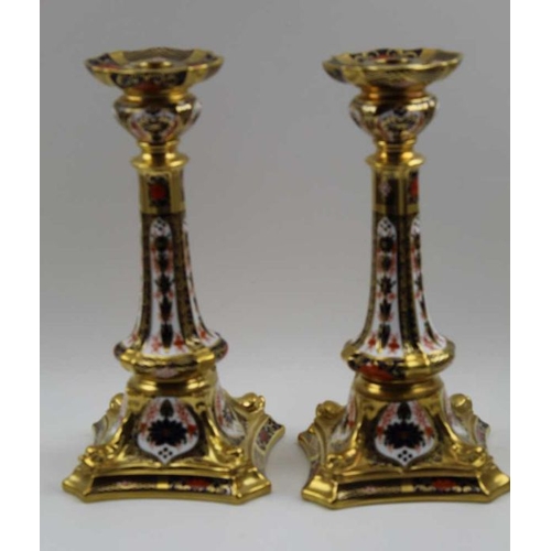 118 - A pair of Royal Crown Derby bone china candlesticks, decorated and gilded in the Imari palette No. 1... 