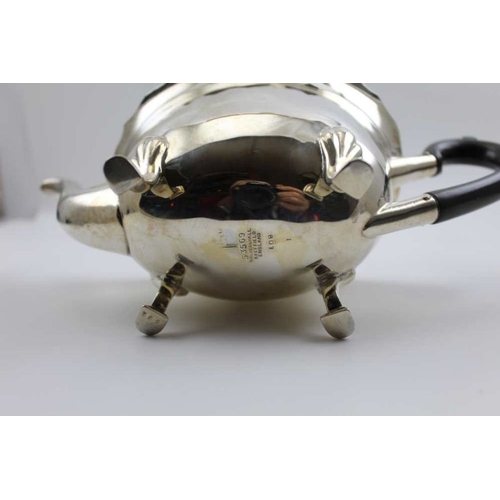 12 - Walker & Hall, A silver teapot, shaped rim, hinged cover, raised on four hoof feet, Sheffield 1914, ... 