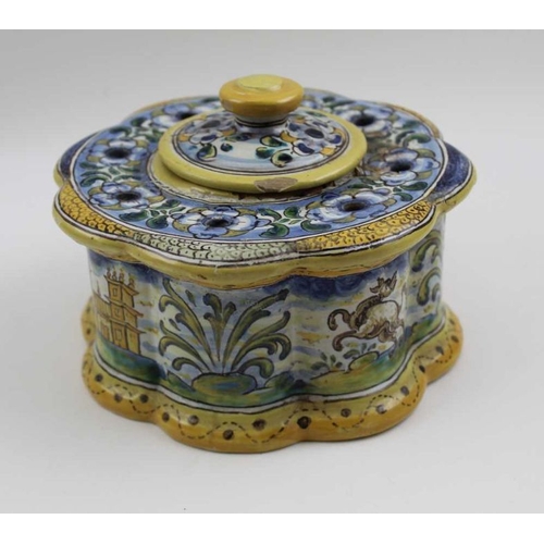 122 - A 19th century Spanish tin glazed Faience earthenware table top inkwell, of lobed design, central we... 