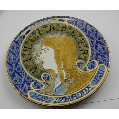 126 - A Lunville Art Nouveau pottery charger, painted and gilded with the profile portrait of a young woma... 