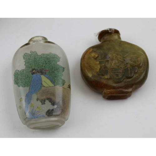 128 - A collection of four Chinese snuff bottles, includes a cast metal one with fish decoration, a carved... 