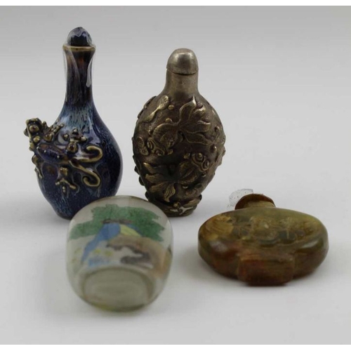 128 - A collection of four Chinese snuff bottles, includes a cast metal one with fish decoration, a carved... 