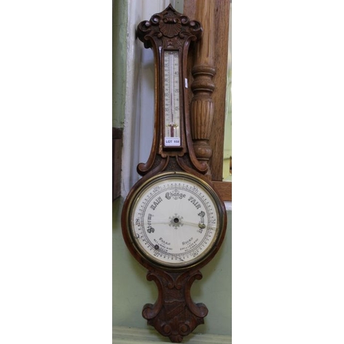 158 - A walnut carved barometer thermometer