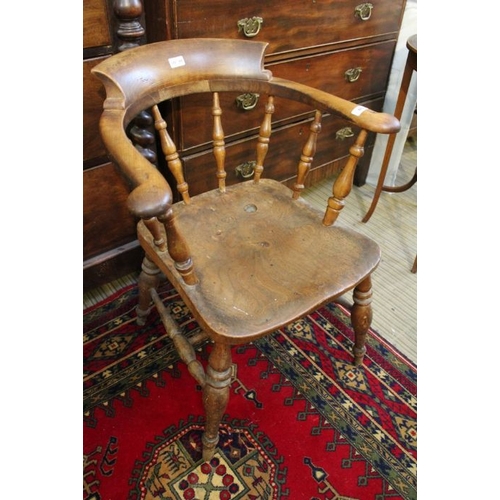 166 - A 19th century elm seated smokers bow arm chair.