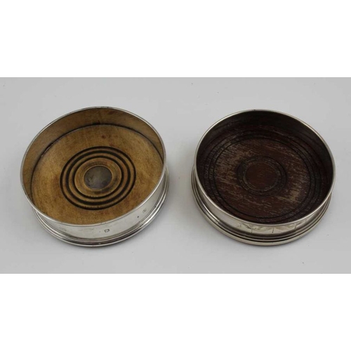 3 - Two Georgian design silver bottle coasters, with turned wood bases, both late 20th century, one Lond... 