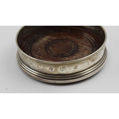 3 - Two Georgian design silver bottle coasters, with turned wood bases, both late 20th century, one Lond... 