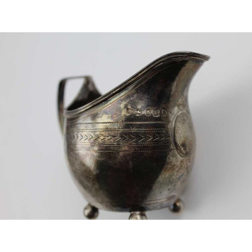 30 - A George III silver milk jug, engraved decoration raised on four ball feet, London 1805, a silver Ch... 