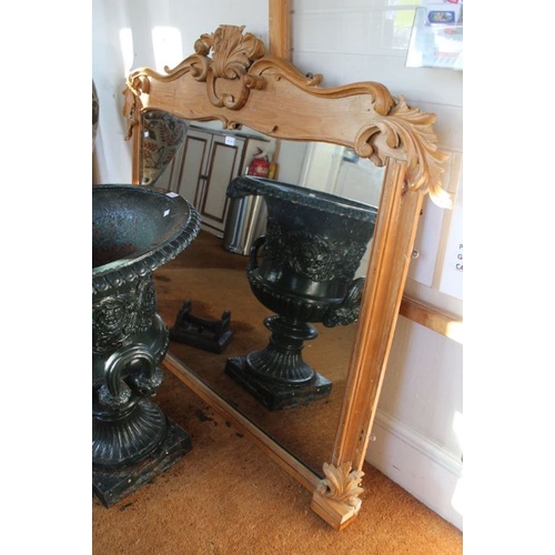 301 - A decorative carved pine frame plain plate over-mantle mirror 121 cm high.