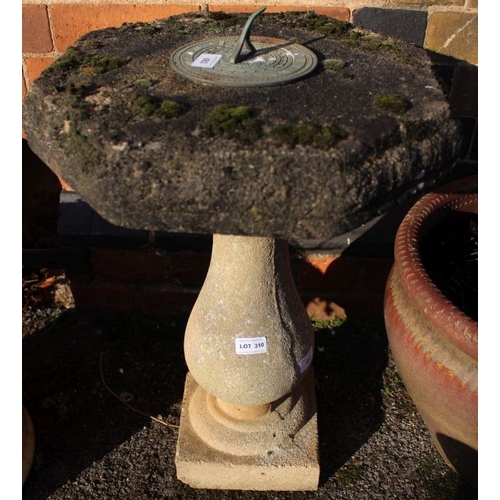 310 - A cast concrete sundial on baluster column pedestal.