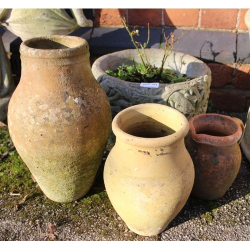 311 - A small cast concrete planter with three terracotta pots.