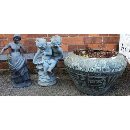 315 - A Verdigris patinated planter with two small garden statutes.