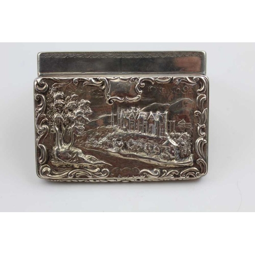 32 - A William IV silver snuff box, the hinged cover decorated with a raised image of a grand country hou... 