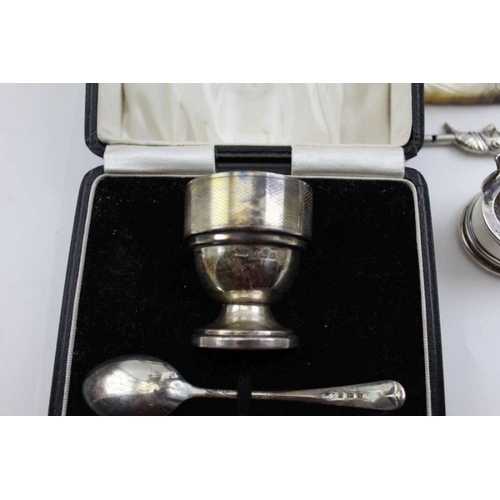 41 - Sanders & Mackenzie, an Art Deco silver egg cup & spoon set, engine turned decoration, in original b... 