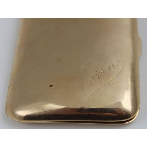 64 - A 9ct gold cigarette case of shaped rectangular form, inscribed 