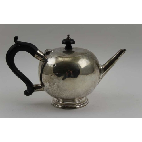 11 - Wakeley & Wheeler, An Irish silver bachelor teapot, of spherical form, on stepped base, Dublin 1917 ... 